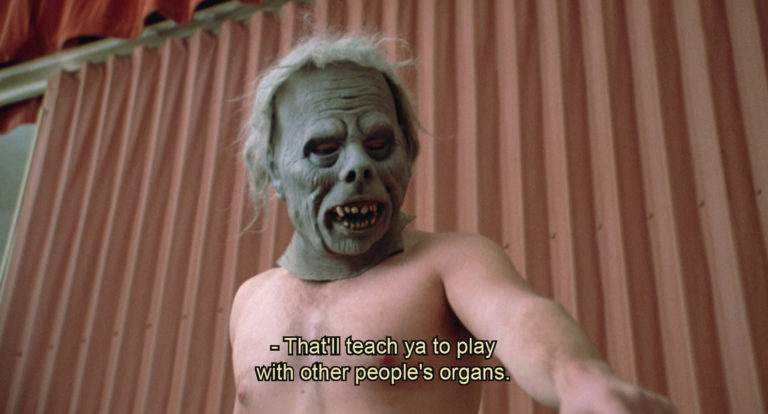 A man in a monster mask in Rush Week (1989).