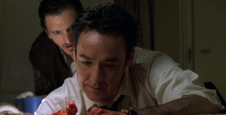 John Hawkes watches John Cusack in Identity (2003).
