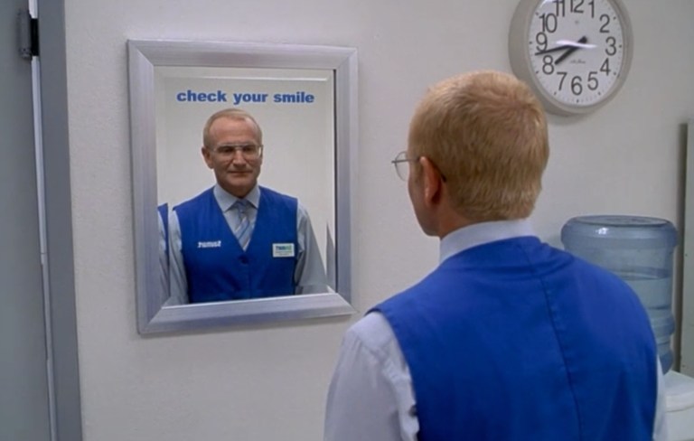 Robin Williams check his smile in a mirror in One Hour Photo (2002).