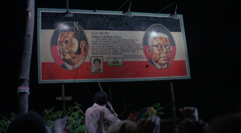Baby Doc and Papa Doc billboard from The Serpent and the Rainbow (1988).