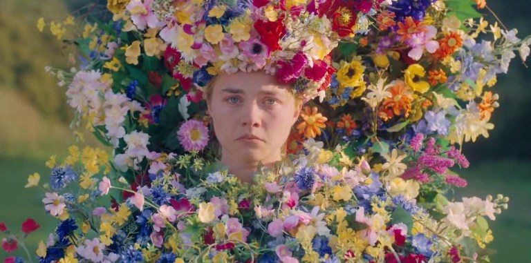 Florence Pugh surrounded by flowers in Midsommar (2019).