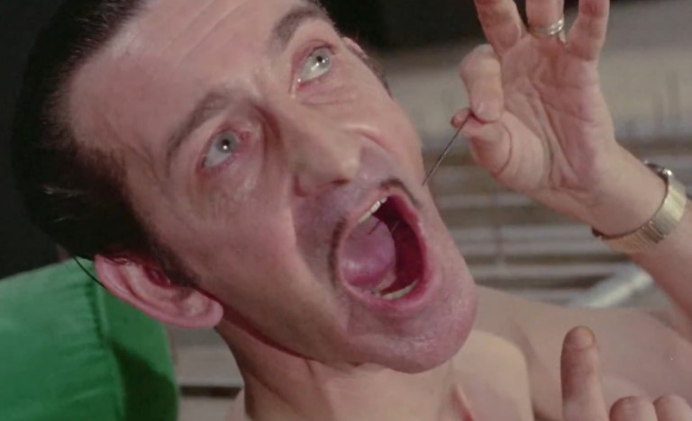 Jack Schwarz driving a needle through his cheek in Mondo Bizarro (1966).