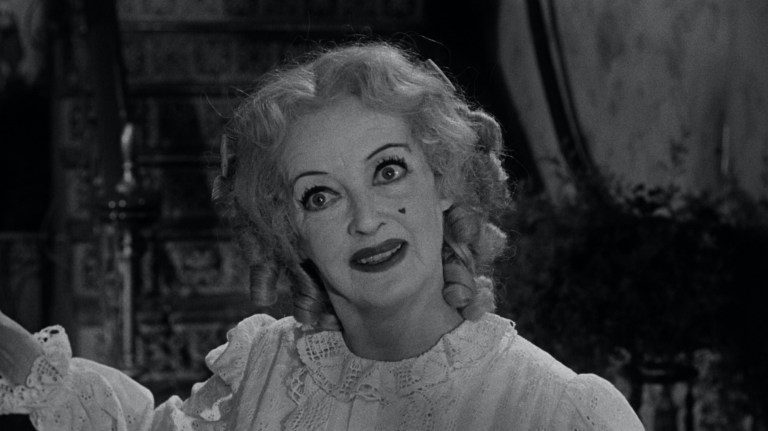 Bette Davis smiles in What Ever Happened to Baby Jane? (1962).