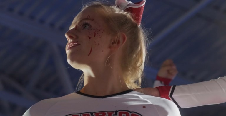 A cheerleader with blood on her face in Bring It On: Cheer or Die (2022)