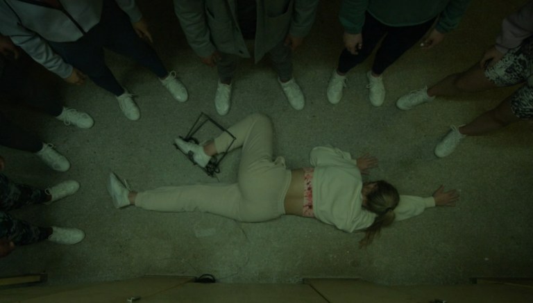 A dead cheerleader on the floor of a bathroom in Bring It On: Cheer or Die (2022).