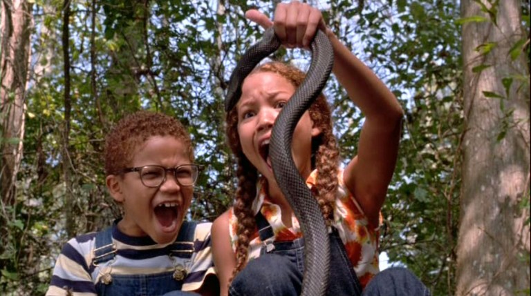 Jurnee Smollett screams as she holds a snake in Eve's Bayou (1997)