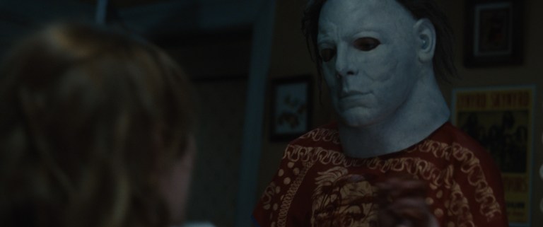 Young Michael Myers wears the iconic white mask while about to kill his sister Judith in Halloween (2007).
