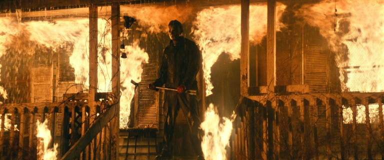 Michael Myers emerges from Laurie's burning compound in Halloween Kills (2021).