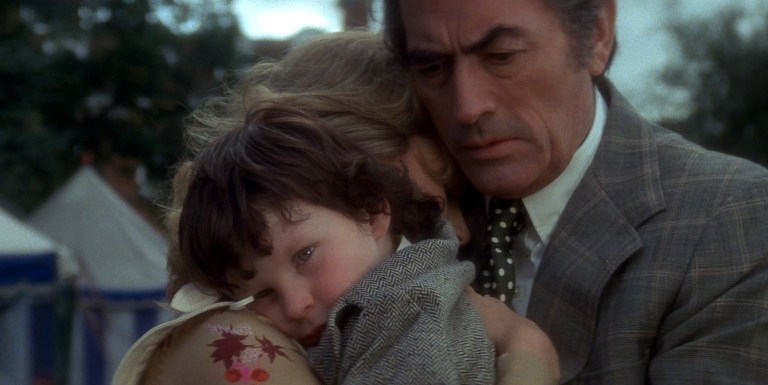 Damien is embraced by his adoptive parents in The Omen (1976).