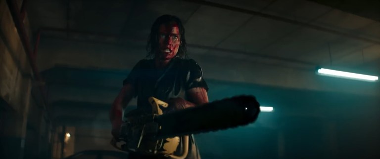 A bloodied Beth wields a chainsaw in Evil Dead Rise (2023).