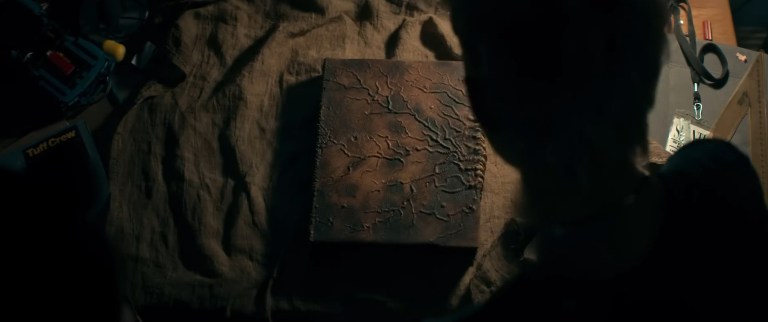 The Necronomicon rests on a table in Evil Dead Rise (2013).