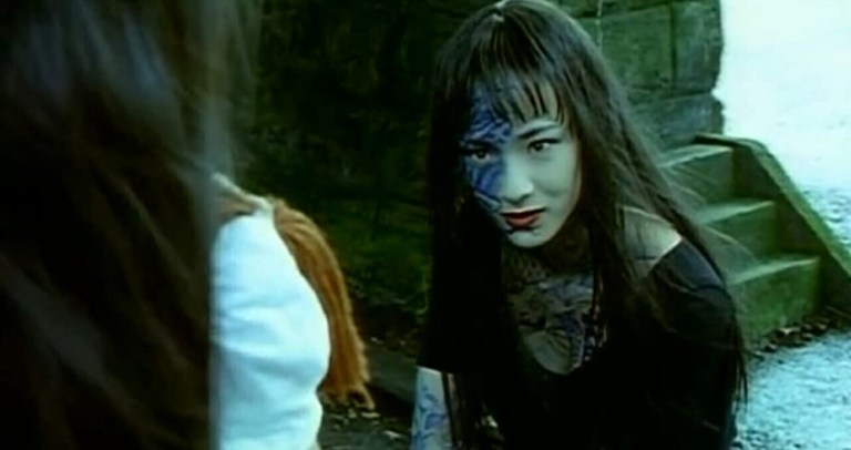 A woman with tattoos appears in Love Ghost (2001).