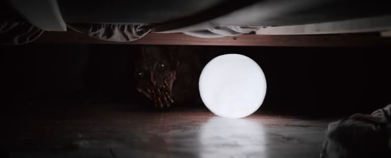 The Boogeyman's face appears under a bed in The Boogeyman (2023).