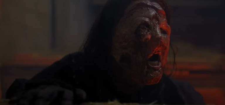 Erika Ervin as Jodi with a melting face in The Price We Pay (2023).