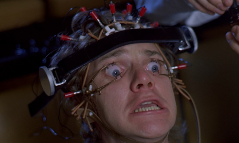 Alex is forced to watch violent images in A Clockwork Orange (1971)