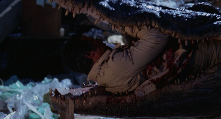 A man is swallowed whole by a huge alligator in Alligator (1980).
