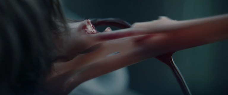 A closeup of Brandon's ear being torn off in M3GAN: Unrated (2023).