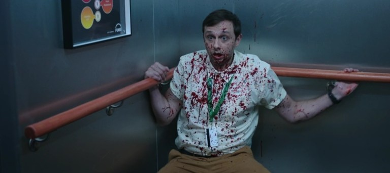 Kurt cowers in the corner of an elevator in M3GAN: Unrated (2023).