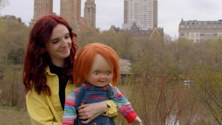 Kyra Gardner holds a Chucky doll in Living With Chucky (2022).