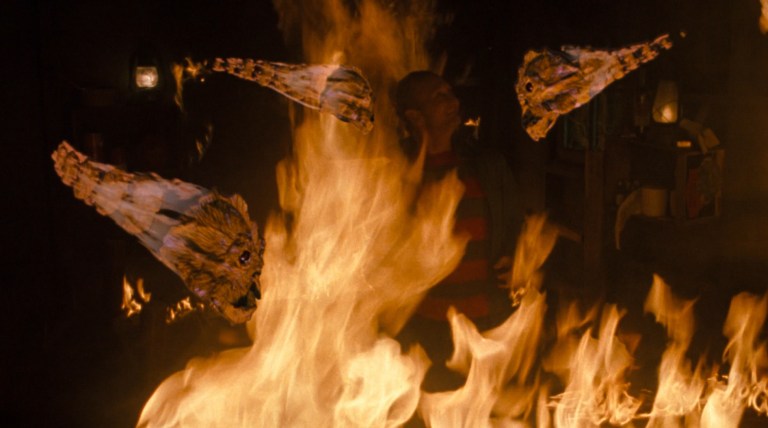 The Dream Demons surround Freddy as he stand in fire, about to be burned to death in Freddy's Dead: The Final Nightmare (1991).