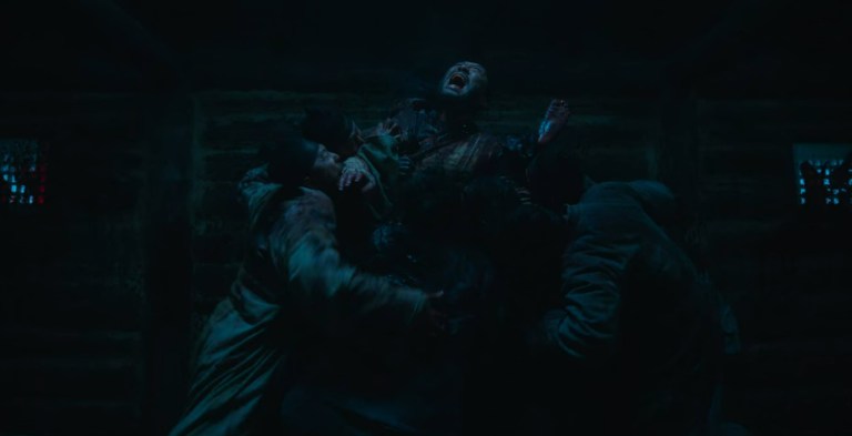 A pile of zombies eat a man in Kingdom: Ashin of the North (2021).
