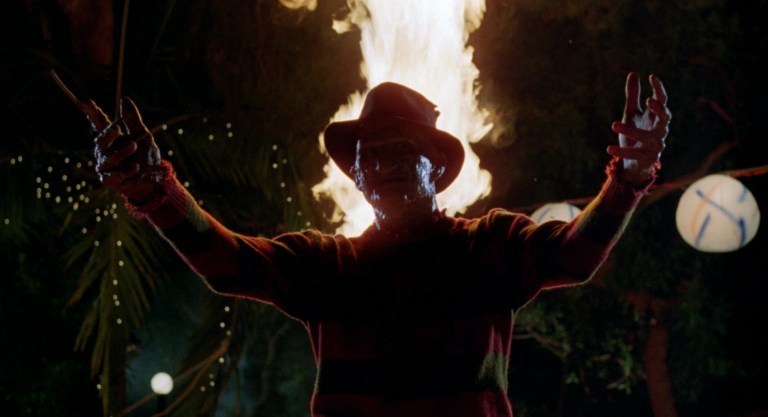 Freddy Krueger spreads his arms at a pool party in A Nightmare on Elm Street 2: Freddy's Revenge (1985).