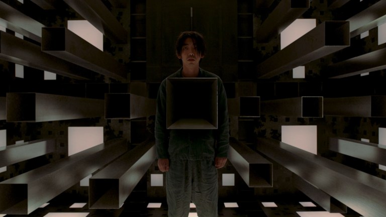 A man has his torso cubed in Cube (2021).