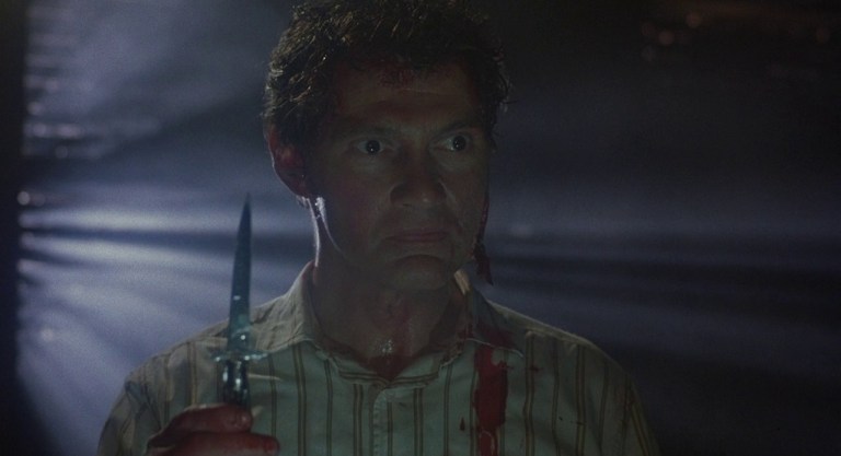 Andrew Robinson as Frank wearing Larry's skin in Hellraiser (1987).