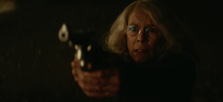 Jamie Lee Curtis points a gun Halloween (2018).