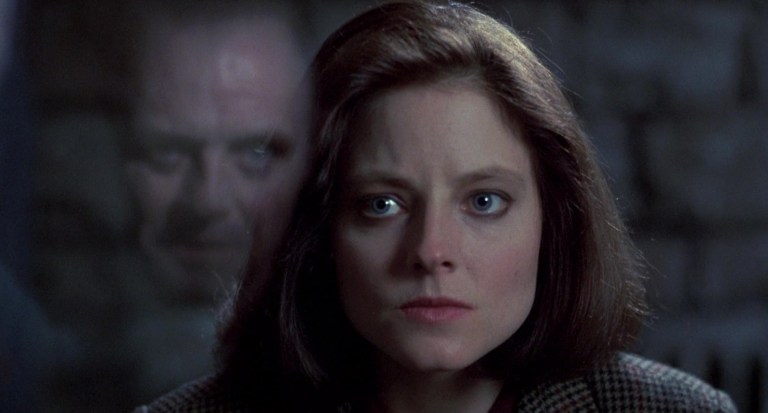 Anthony Hopkins is reflected in glass in front of Jodie Foster in The Silence of the Lambs (1991).
