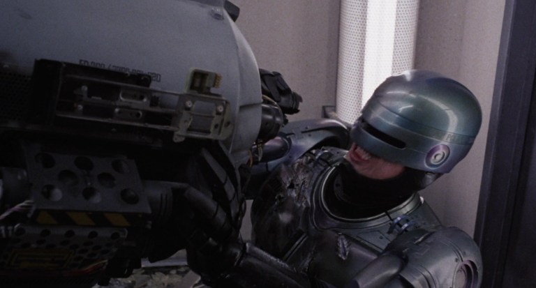 Robocop (Peter Weller) battles ED-209 in Robocop (1987).