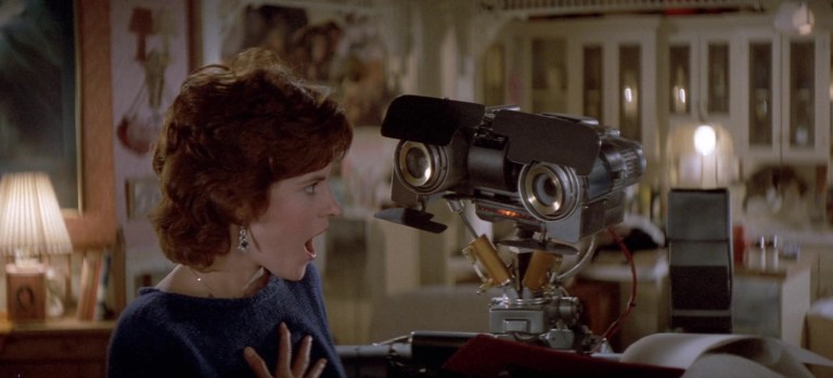 Ally Sheedy and Johnny 5 (voiced by Tim Blaney) in Short Circuit (1986).