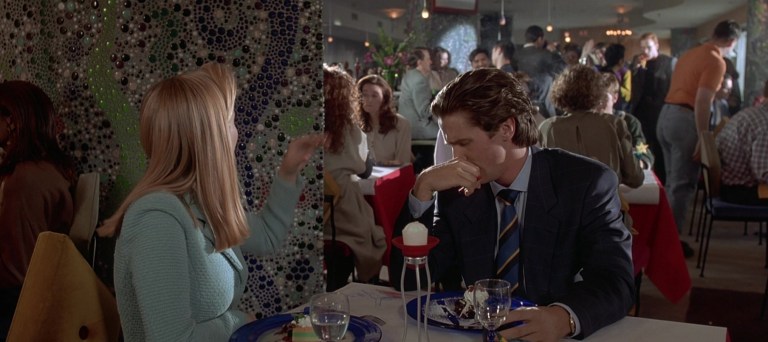 Patrick Bateman looks at an image of murder while having dessert in American Psycho (2000).