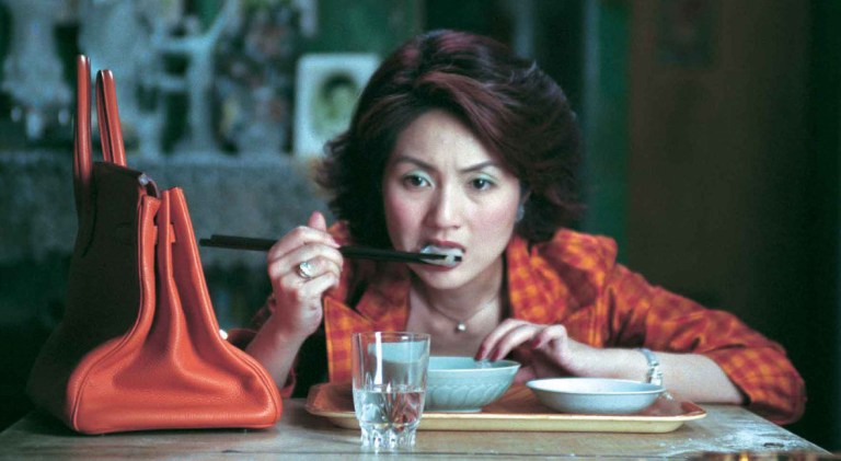 Miriam Yeung eats a dumpling in Dumplings (2004).
