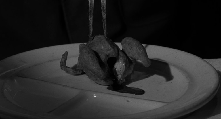 A cooked chicken bleeds on a plate in Eraserhead (1977).