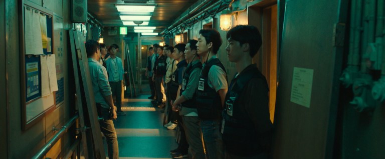 Police line the hallway of a ship in Project Wolf Hunting (2022).