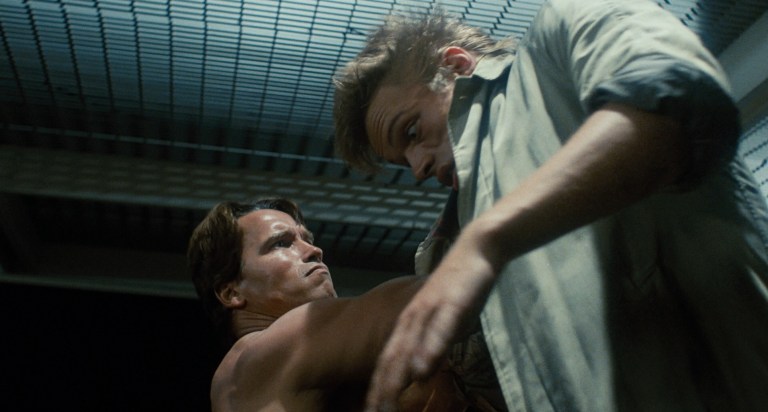 The T-800 punches a hole in the chest of a punk in The Terminator (1984).