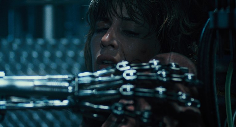 A chrome skeleton hand reaches for Sarah Connor in The Terminator (1984).