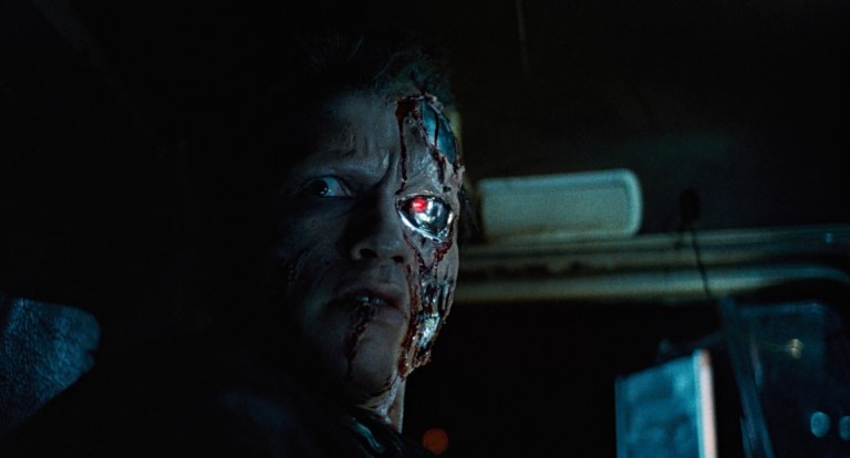 The T-800 with torn skin and a glowing red eye in The Terminator (1984).