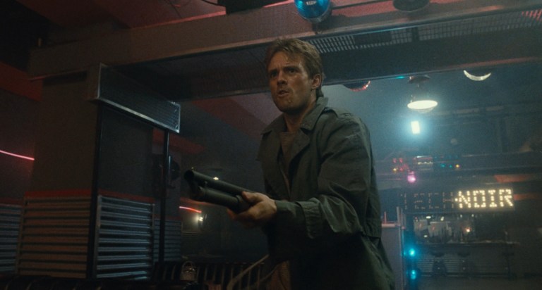 Kyle Reese holds a shotgun in The Terminator (1984).