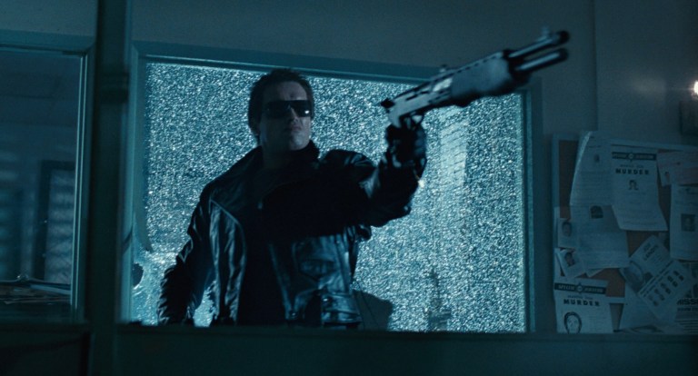The T-800 points a shotgun in THe Terminator (1984).