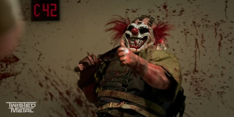 Sweet Tooth gives a thumbs up in front of a bloody wall in Twisted Metal (2023).