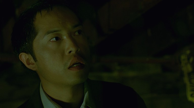 Ken Leung as Steven Sing in Saw (2004).