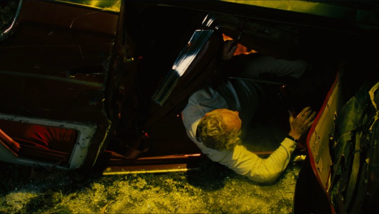 John Kramer survives a car crash in Saw II (2005).