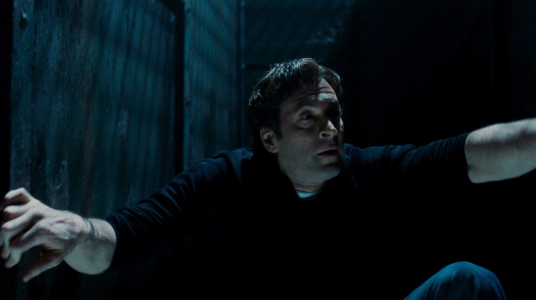Strahm trapped in a room with moving walls in Saw V (2008).