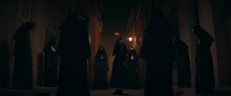 Irene is surrounded by multiple nuns in The Nun II (2023).