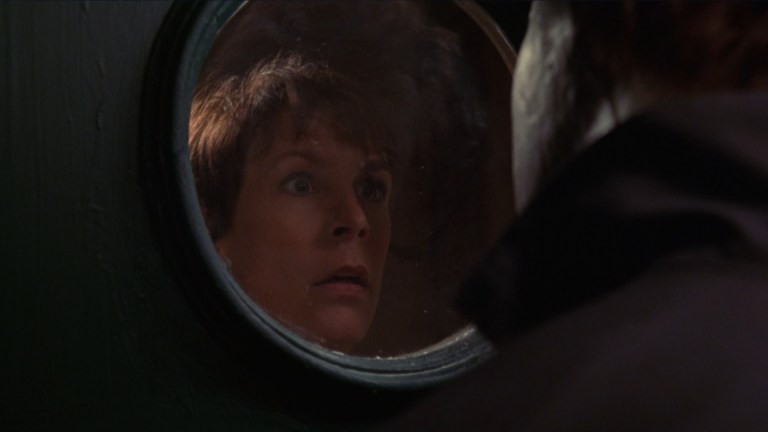 Laurie stares at Michael through a window in Halloween: H20 (1998).