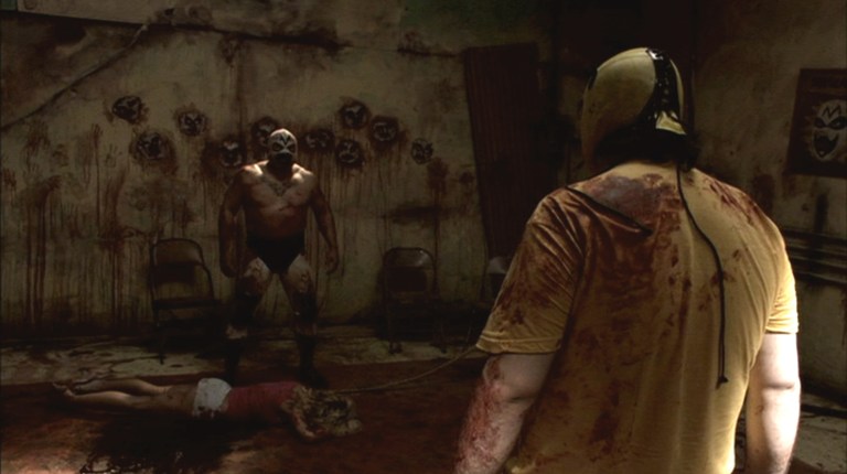 El Mascarado stands in a bloody room in Wrestlemaniac (2006).