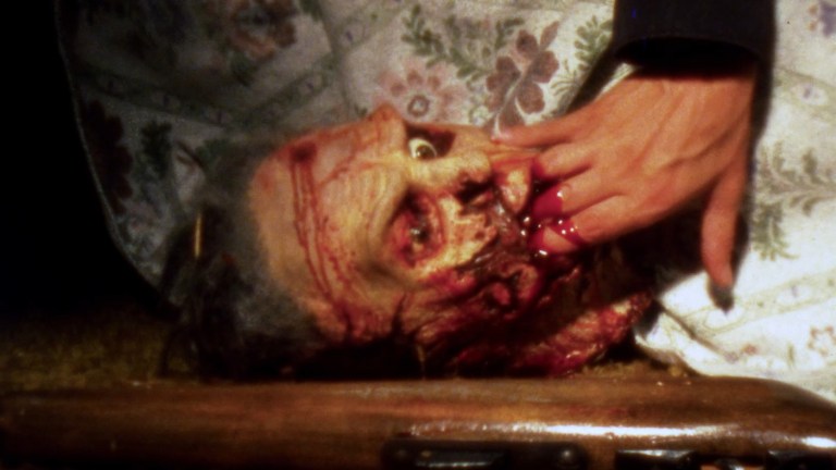 A zombie's severed head bites a man's fingers in The Dead Next Door (1989).