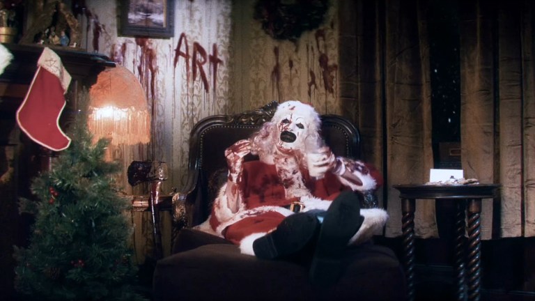 Art the Clown eats a cookie in the Terrifier 3 teaser trailer.